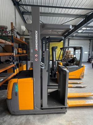 a forklift in a warehouse with pallets on the floor
