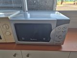 a microwave sitting on a counter next to a microwave oven