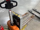 a forklift that is sitting on the ground in a warehouse