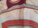 a close up of a scarf with a horse on it