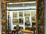 a mirror on the wall above a desk in a room