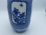 a blue and white vase with flowers on it