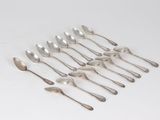 a set of six silver spoons on a white surface