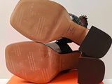 a pair of shoes that are on top of an orange box