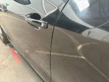 a close up of a car door handle with a sticker on it