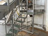 a metal staircase going up to the top of a building