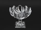 black and white photograph of a glass bowl with spoons in it