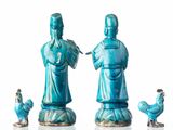 three figurines of a man and a woman and a rooster