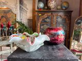 a vase and a bowl on a table in a room
