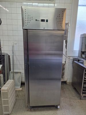 a stainless steel refrigerator in a kitchen with a lot of counter space