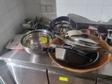 many pots and pans sitting on the counter in the kitchen