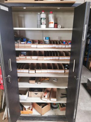 a metal cabinet that has many shelves in it