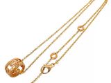 a close up of a gold chain with a ring on it