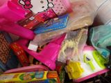 a pile of toys in a basket with a hello kitty sign on it