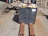 a forklift that is sitting on the ground in front of a building