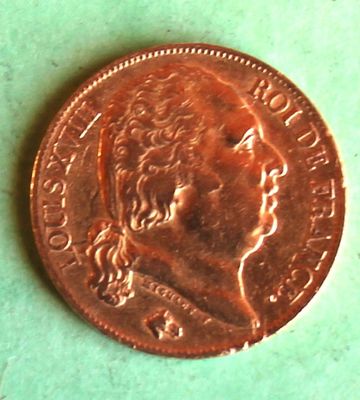 a close up of a penny on a green surface