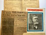 several old newspapers are displayed on a table in a room