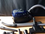 a vacuum that is sitting on a table next to other items