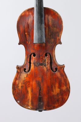 an old violin on a stand against a white background