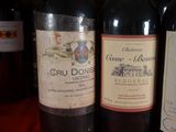 several bottles of wine are lined up on a table