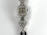 a silver and black watch with a black band