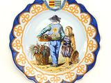 a plate with a picture of a man and a dog on it