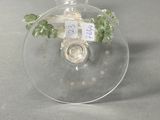 a clear glass ornament with a green plant inside of it
