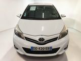 the front of a white toyota yaris parked in a white room