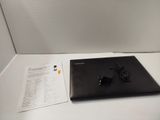 a laptop computer sitting on a table with a charger on it