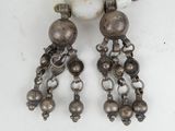 a close up of a pair of earrings on a table