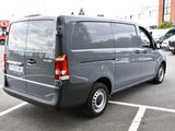 a grey van that is parked in a parking lot