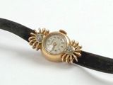 an image of a gold watch with diamonds on a black band