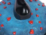 a blue cake with red hearts on it and a black cat on top