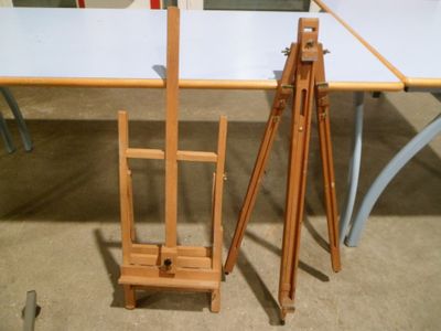 two easels and a wooden easel on the floor