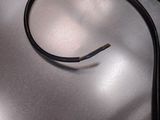 a black wire that is on top of a metal table