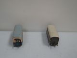 two toy trains sitting on a table next to each other
