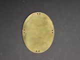 a close up of a brass plate on a black surface