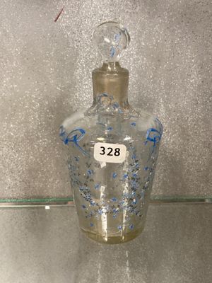 a glass bottle with a number on it sitting on a glass shelf