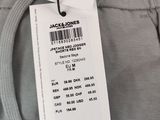 the label on the back of a pair of grey pants with a picture of a woman in a bra top