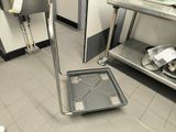 a metal floor with a tray on it in a kitchen