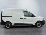 the small white van is parked in a large room