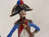 figurine of a man dressed in a military uniform holding a cane