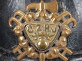 a close up of a helmet with a gold emblem on it