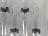 five empty bottles in a clear plastic container