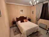 a bedroom with a bed and a chair in it