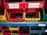 many bins of different kinds of screws on the shelf