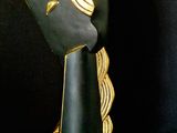 a black and gold sculpture of a man ' s head