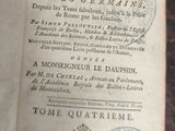 an old book that is open on a table