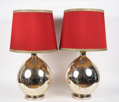 pair of silver and red lamps with red shades on a white background