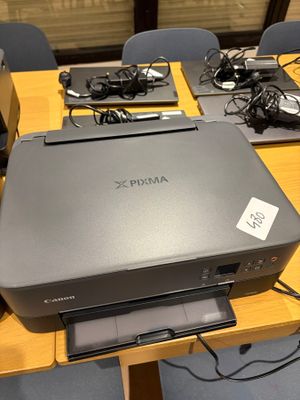 a printer sitting on top of a wooden table